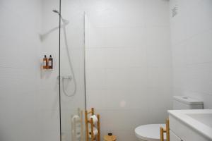 a bathroom with a shower and a toilet at Nia Azorean Apartments in Horta +17 photos