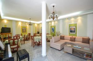 a living room with a couch and a dining room at Naxos Hotel Savvas in Naxos Chora