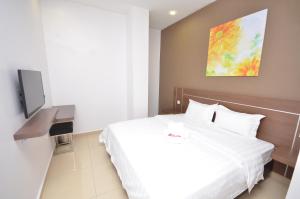 a hotel room with a bed and a tv at AST Hotel in Alor Setar