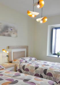 Posteľ alebo postele v izbe v ubytovaní Apartamentos Turísticos Hornillo AT-CC-00681