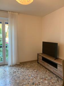 ein Wohnzimmer mit einem Flachbild-TV auf einem Entertainment-Center in der Unterkunft casa Dante in Riva del Garda