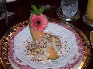 a pink flower on a plate on a table at Shadowlawn Bed and Breakfast in Columbus