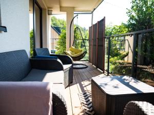 a patio with chairs and a table on a balcony at Apartament Lux View Szczyrk Sauna Jacuzii in Szczyrk +45 photos