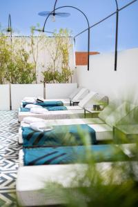 a group of mattresses and couches on a patio at Le Pavillon de la Kasbah & SPA Marrakech in Marrakech