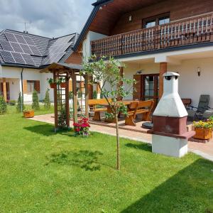 a house with a garden with a solarium at Apartamenty Pod Magnolią in Białowieża