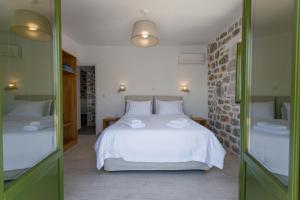 Postel nebo postele na pokoji v ubytování ARIS-APEA Villas + 37 fotografií