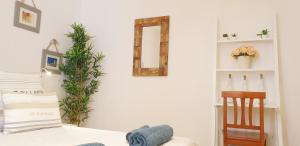 a bedroom with a bed and a mirror on the wall at La casa Rosa in Ponza