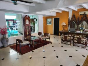 a living room with a table and a grandfather clock at The Boutique Residence Hotel in George Town