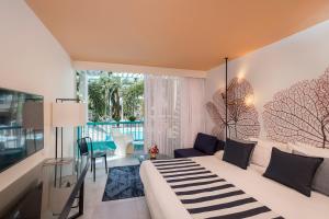 a bedroom with a large bed and a living room at Yam Suf by Isrotel Collection in Eilat +102 photos