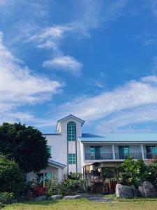 a large white building with a tower on top at TIAMAT Diving Club X 苦水輕旅 in Hengchun South Gate