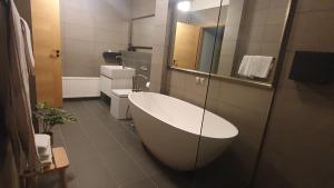 a bathroom with a bath tub and a sink at Old Town Apartment in Pärnu +4 photos