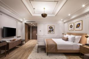 a bedroom with a bed and a flat screen tv at Mula Hotel in Istanbul