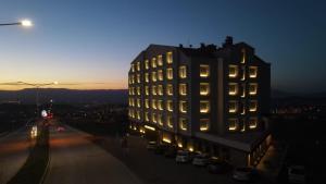 a building with lights on the side of it at night at The Erzurum Hotel in Erzurum