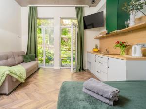 a living room with a couch and a kitchen at House 22A Studio Apartments in Kaunas