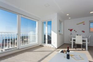 a dining room with a view of the ocean at Apartment Alius Ragusa Deluxe in Dubrovnik