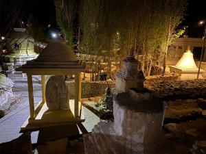 a street light in a garden at night at Gomang guest house Leh in Leh