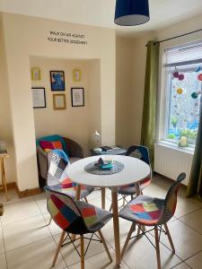 a living room with a table and chairs at An Lar in Bellaghy