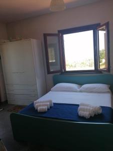 a bedroom with a bed with two pillows on it at Open Space a due passi dal mare in Ustica