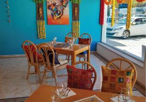a dining room table and chairs in front of a window at Muthu Clube Praia da Oura in Albufeira