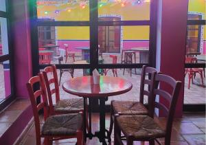 a table and chairs in a restaurant with a window at Muthu Clube Praia da Oura in Albufeira