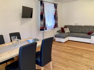 a living room with a table and a couch at Appartement Melodie in Scheffau am Wilden Kaiser