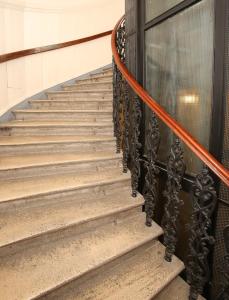 a staircase with an orange rope next to a door at Apartments Vienna Opera in Vienna