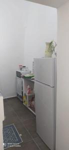 a kitchen with a white refrigerator in a room at Villa adriana in Pantelleria