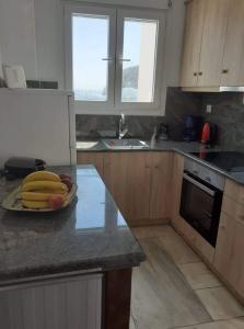 a kitchen with a plate of bananas on a counter at Anastasia House in Apollon