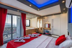 a bedroom with a large bed and a bathroom at ULTRA LÜX VİLLA Viranlar in Fethiye
