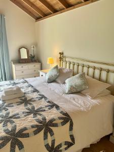 a bed with two pillows on it in a bedroom at The Billiard Room - Cosy Country Retreat in Abergavenny