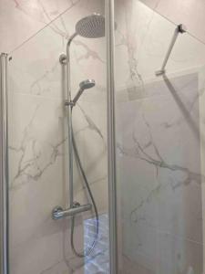 a shower with a glass door in a bathroom at Jolie maison de pêcheur ARAGO aux Sables d'Olonne in Les Sables-dʼOlonne