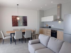a kitchen and dining room with a table and a couch at Apartment Noel Cavtat 1 in Cavtat