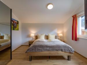 a bedroom with a large bed and two lamps at Going EASY in Going