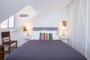 a bedroom with a large bed and two lamps at Designer Flats in Lapa by LovelyStay in Lisbon