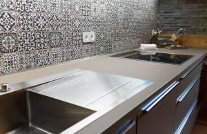 a kitchen with a sink and a counter top at StrandBerg's Harzchalet in Braunlage +26 photos