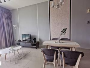 a living room with a dining table and chairs at 11-Modern HOMESTAY PALAZIO lake view Mount Austin Palazio near AEON Themepark Toppen IKEA in Johor Bahru