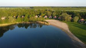 an aerial view of a lake with a group of houses at Vakantiepark 't Broeckhuys in Ewijk +72 photos