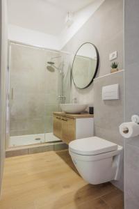 a bathroom with a toilet and a sink and a mirror at Apartments Piritus in Split +16 photos
