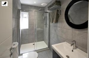a bathroom with a shower and a toilet and a sink at Blackbird Accommodation and Luxury Apartments room 14 in Blackpool +12 photos