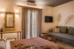 a living room with a couch and a mirror at Avithos Resort Hotel in Svoronata