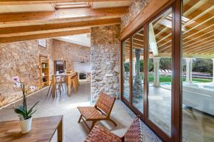an open living room with a stone wall at Can Estela in Sencelles