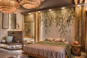 um quarto com uma cama com uma grande pintura na parede em Avithos Resort Hotel em Svoronata