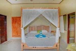 a bedroom with a bed with a canopy at Acarya Bungalows Amed in Amed