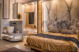 a bedroom with a large bed with a painting on the wall at Avithos Resort Hotel in Svoronata