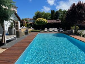 a swimming pool in a yard with a wooden deck at Penzion Trattoria in Prešov