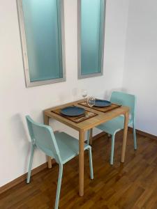 a table and two chairs with wine glasses on it at Lovely studio apartment in Pafos in Paphos