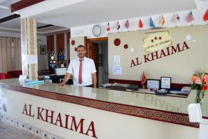 a man standing in front of a counter in a restaurant at Hotel Al Khaima in Asilah