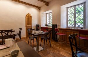 a restaurant with tables and chairs and a bar at La Casermetta in Santa Maria Maggiore