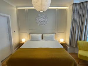 a bedroom with a bed and a yellow chair at Beach Lodge in Bournemouth