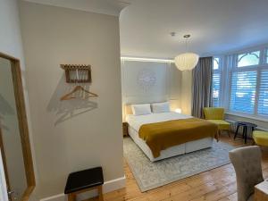 a bedroom with a bed and a living room at Beach Lodge in Bournemouth